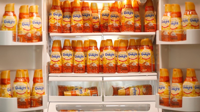 A fridge stocked with many bottles of creamer