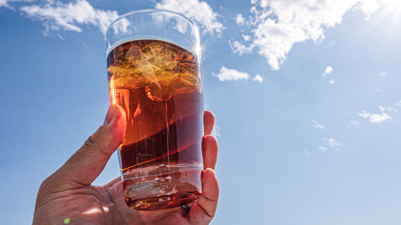 A glass of iced tea against a sunny blue sky