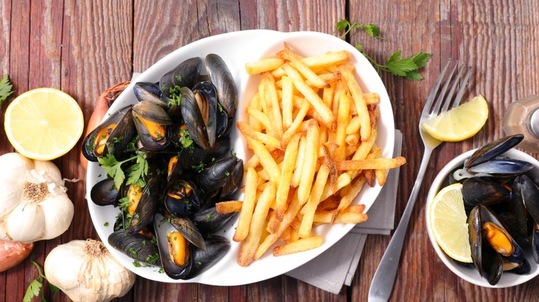 mussels and french fries on a white plate