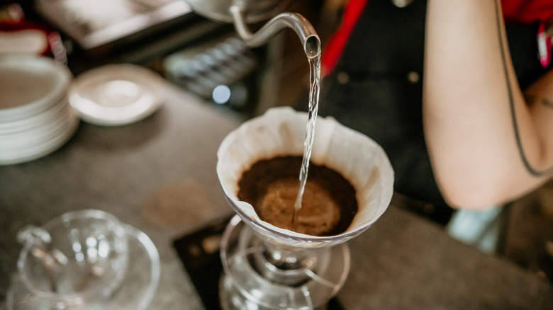 Water being poured over coffee grounds