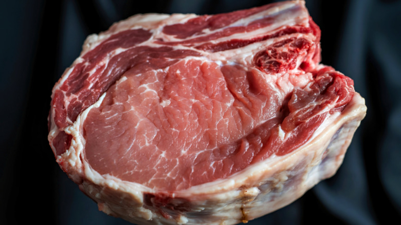 thick bone-in raw pork chop