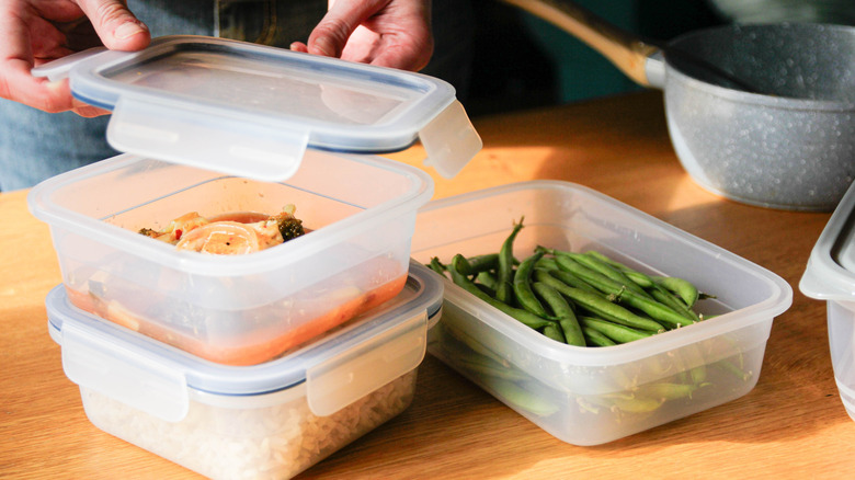 Packing food into plastic storage containers
