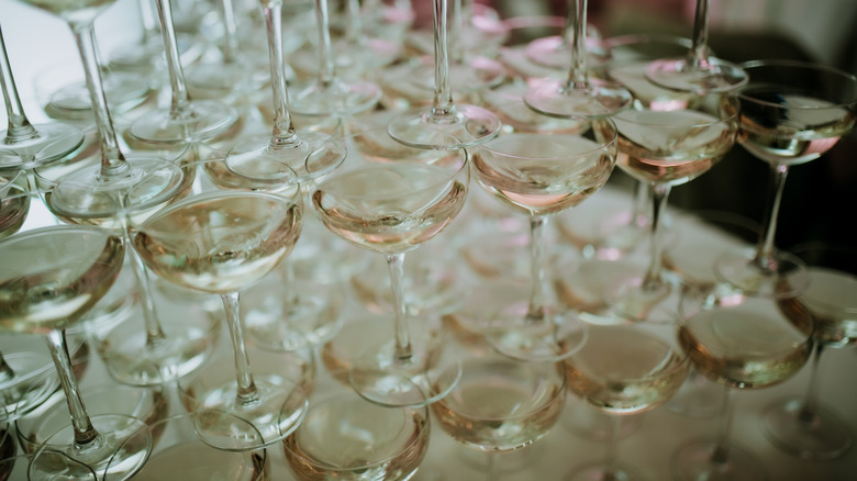 Full champagne glasses stacked in a tower