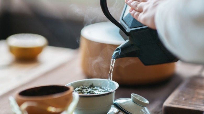 A woman pouring tea in a Chinese tea ceremony.