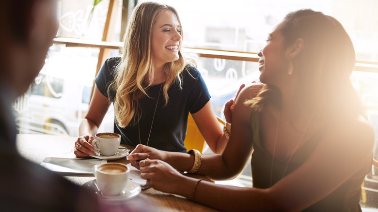 People happy, sitting together in a coffee shop