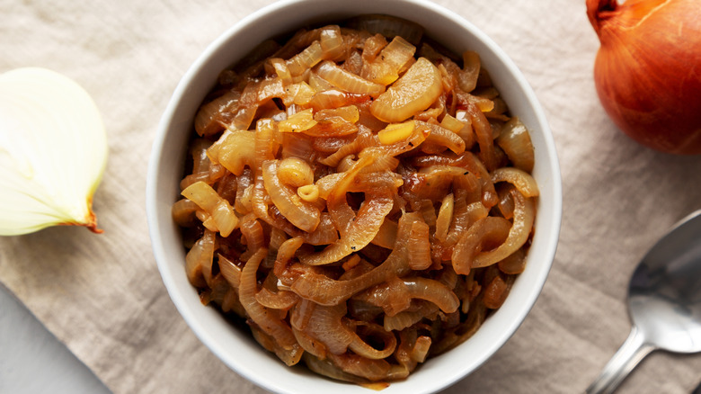 Top view of a small white bowl of caramelized onions