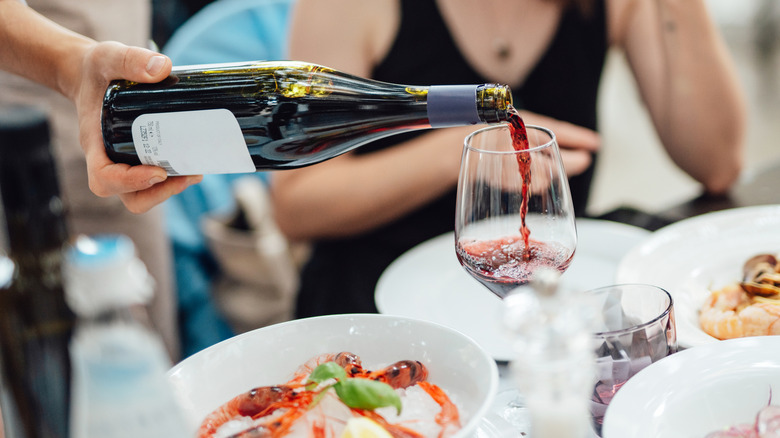 Server pouring wine at restaurant