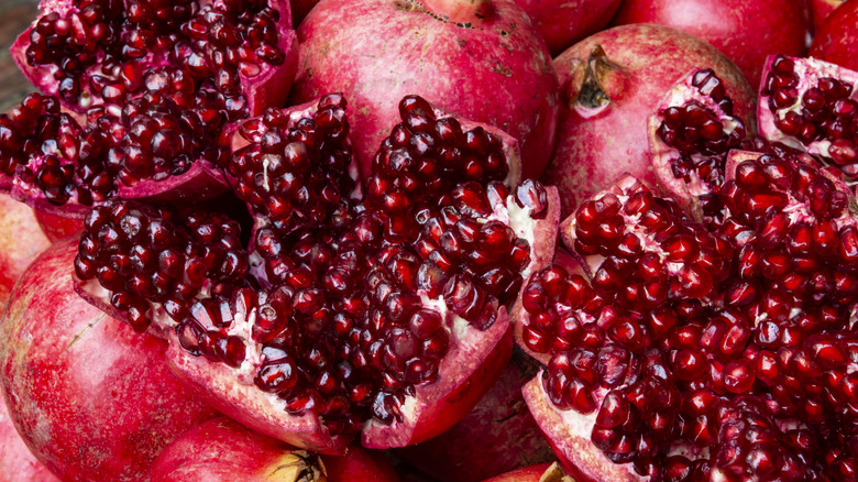 Juicy pomegranates stacked up and cut open.