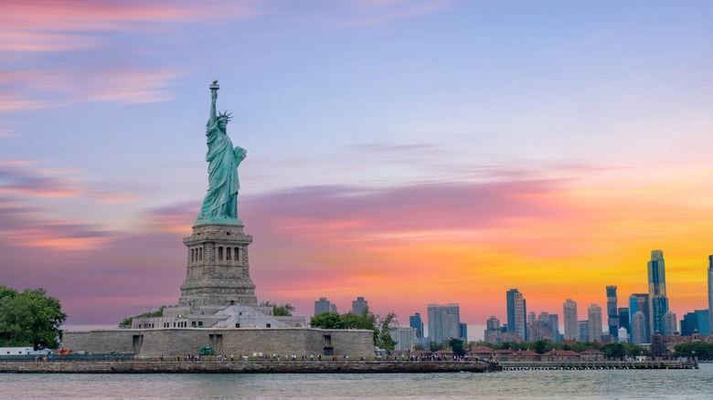 The Statue of Liberty with the New York City skyline in the background.