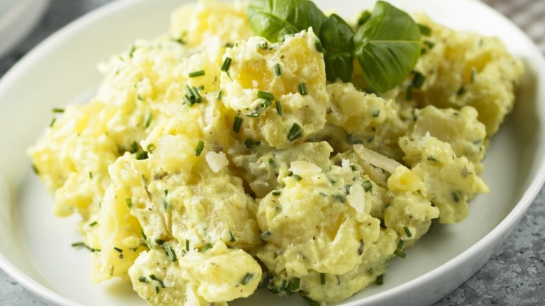A potato salad with fresh herbs on a plate