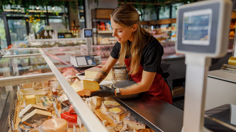 A worker behind the deli counter