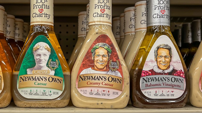 Three bottles of Newman's Own salad dressing on shelf
