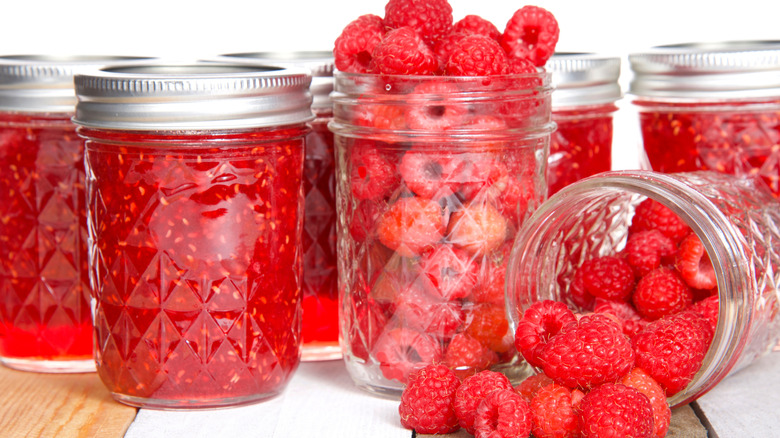Raspberries and raspberry jam in mason jars