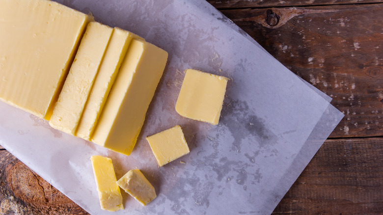 A sliced stick of butter on paper