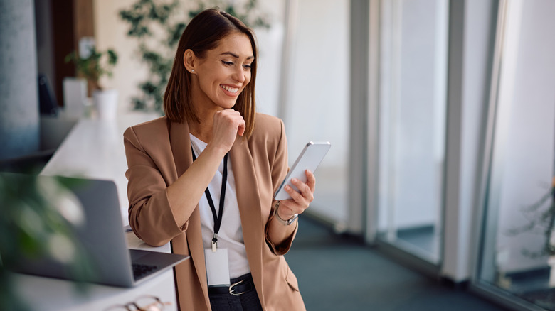 Happy female entrepreneur using a smart phone