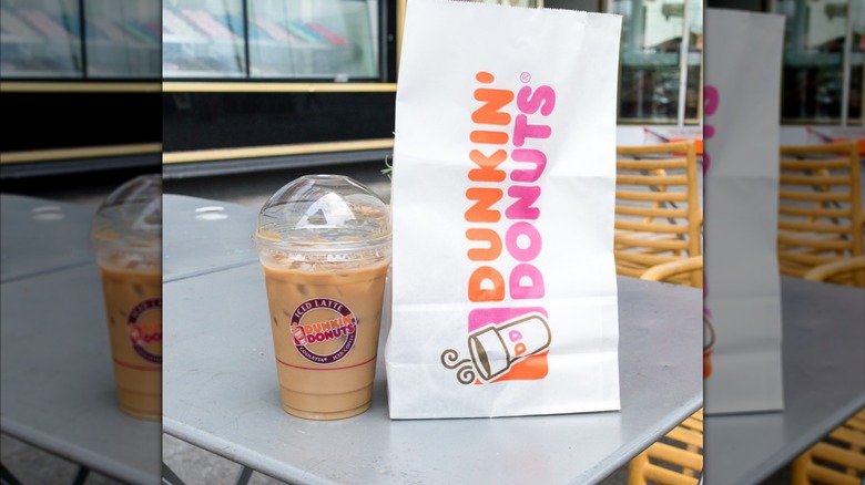 An iced coffee and bag of food from Dunkin' Donuts