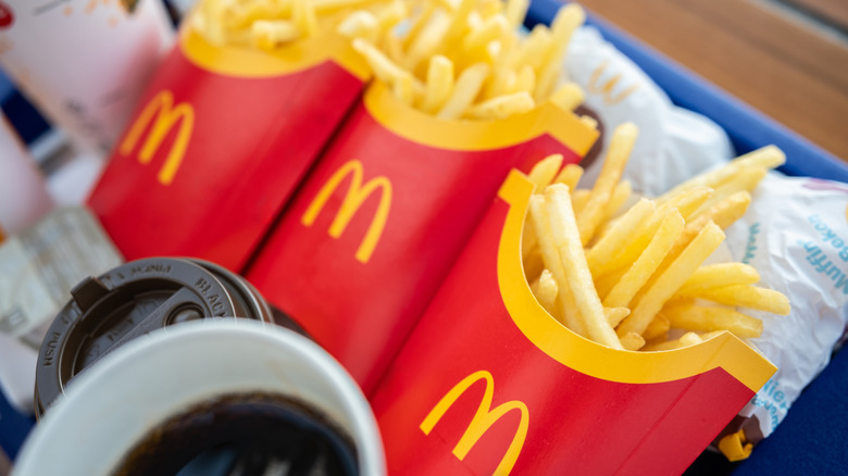 Three boxes of McDonald's fries with the iconic golden M branding