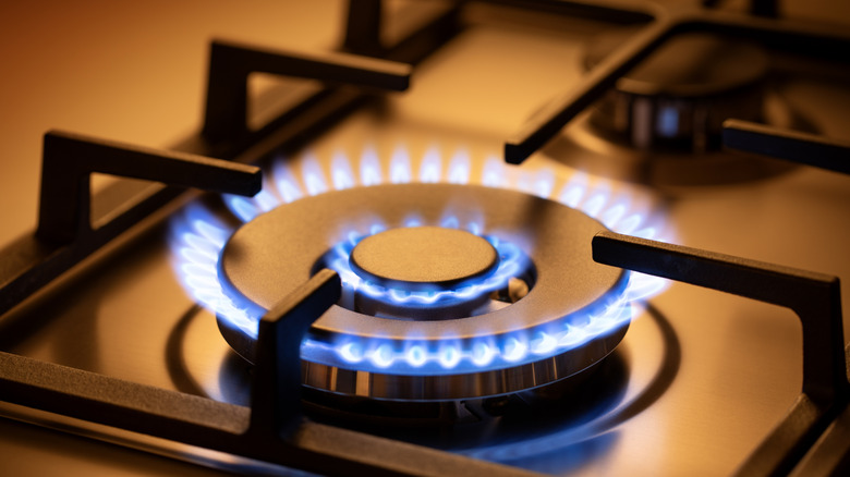 close up of gas stove top with open flame