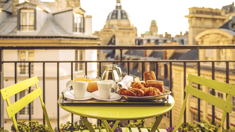 Assembled breakfast in Paris served on a terrace table with city in the back