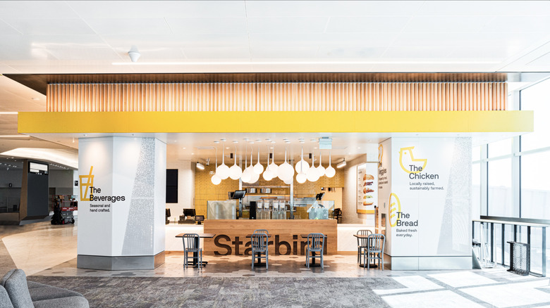 Starbird Chicken location with tables and chairs and floor to ceiling glass windows on the right