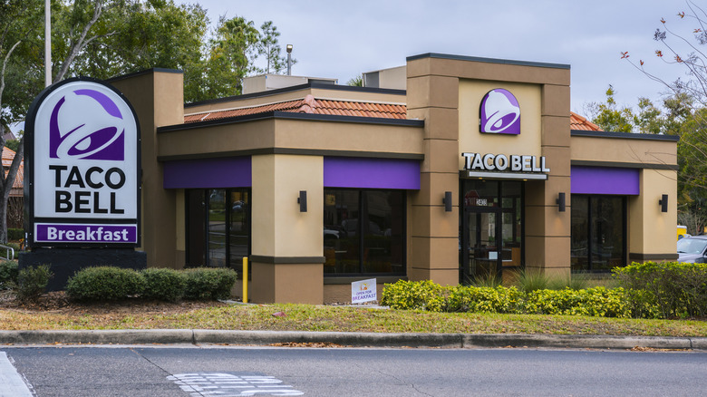 A Taco Bell restaurant with purple signage