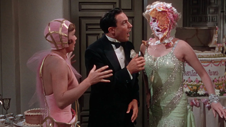 Glamorous woman with cake smashed in her face