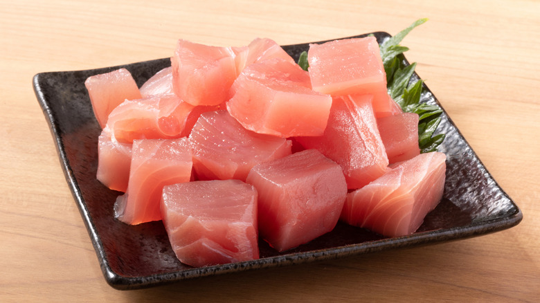 Cut sashimi on a black square plate