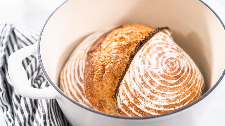 sourdough loaf in a white Dutch oven