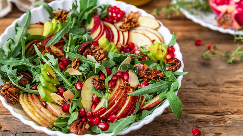 Arugula salad with apples, avocado, pecans, and pomegranate arils