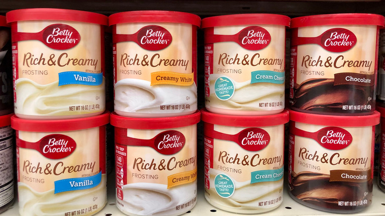 Cans of Betty Crocker frosting on store shelf