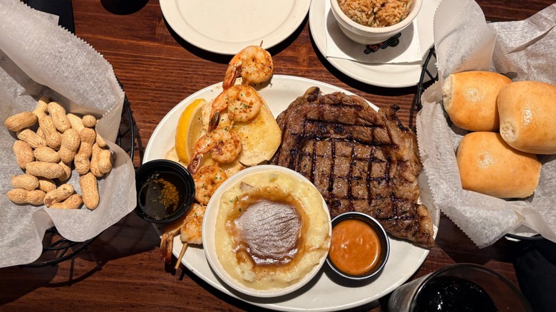 Texas Roadhouse ribeye with shrimp, mashed potatoes, and peanuts