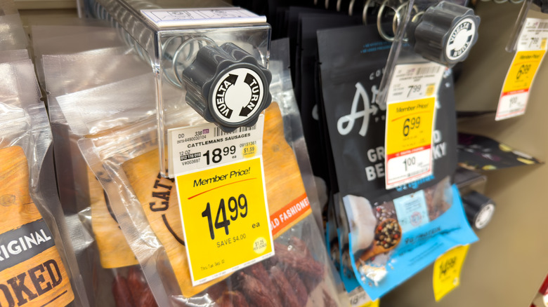 Price tags on a grocery store selection of meat sticks and jerky