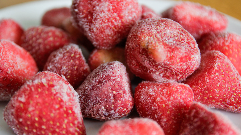 A pile of frozen strawberries sitting on a plate