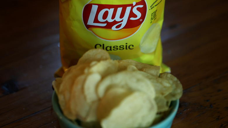 Bag and bowl of Lay's potato chips
