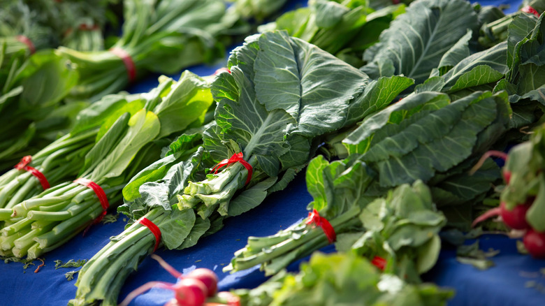 Bunches of collard greens on display at farmers market