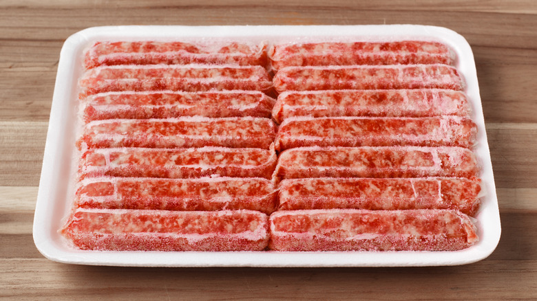 A pack of frozen sausages with freezer burn