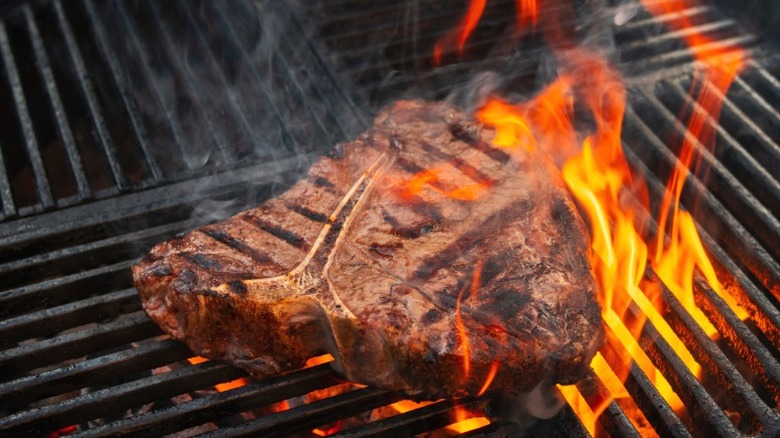Porterhouse steak on a grill.