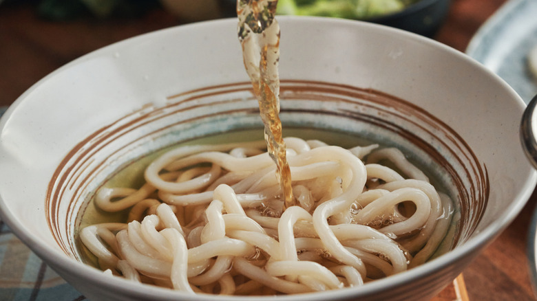 A bowl of udon noodles in broth