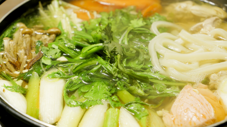 Up-close view of hot pot broth with various ingredients