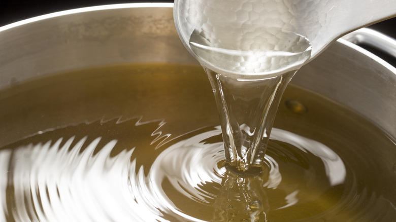 Japanese broth in a metal pot with a ladle