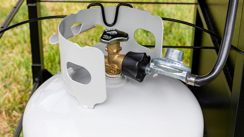 Propane tank attached to grill