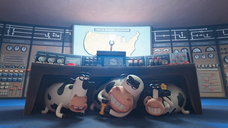 Chick-fil-A's cow mascots hiding under a desk at Circus Burger Code Moo film