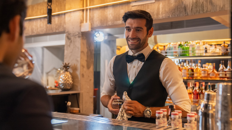 bartender making eye contact with guest from behind bar
