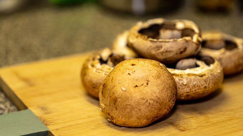 portobello mushrooms on a wooden board