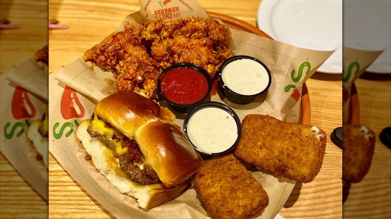 Chili's Triple Dipper with fried mozzarella rectangles, mini burgers, fried chicken strips, two small cups of white sauce and one small cup of red sauce