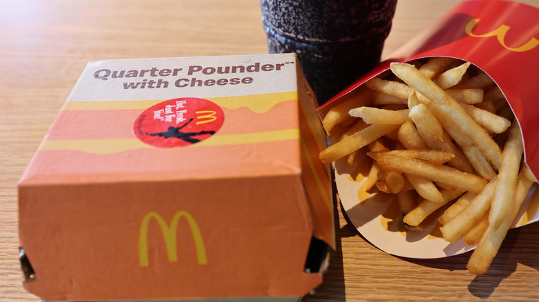 A McDonald's Quarter Pounder box beside french fries and a drink