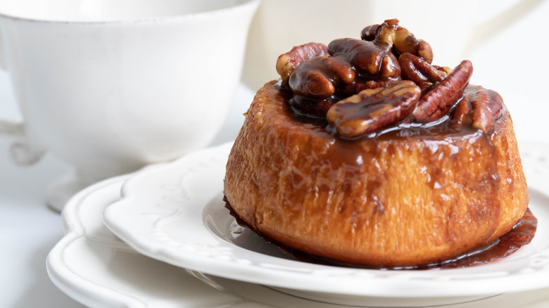 Pecan sticky bun on white plate