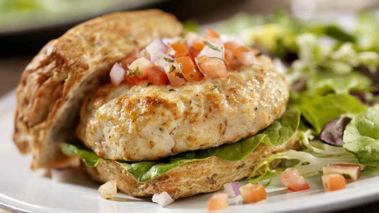 Ground chicken burger with pico de gallo and side salad