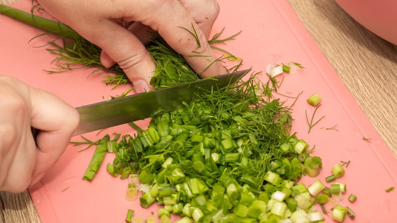 Person chopping fresh herbs