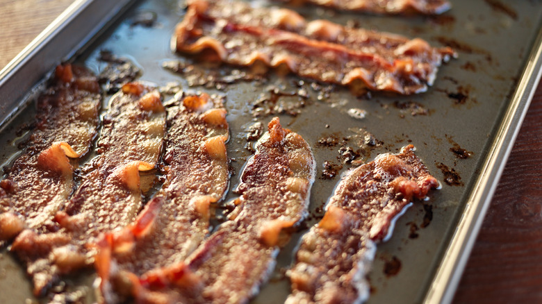 Bacon cooking in oven kitchen tray